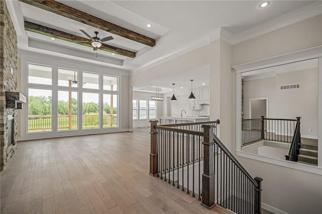 19389 W 114th Ter, Olathe, KS 66061 - hallway featuring an upstairs landing, wood finished floors, recessed lighting, beamed ceiling, and a tray ceiling