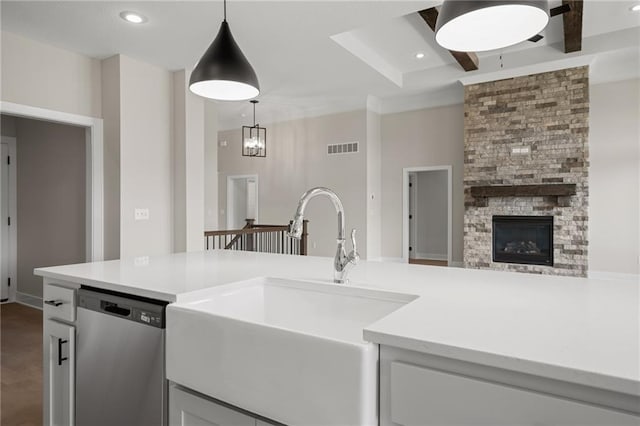 19389 W 114th Ter, Olathe, KS 66061 - kitchen with stainless steel dishwasher, a sink, light countertops, open floor plan, and hanging light fixtures
