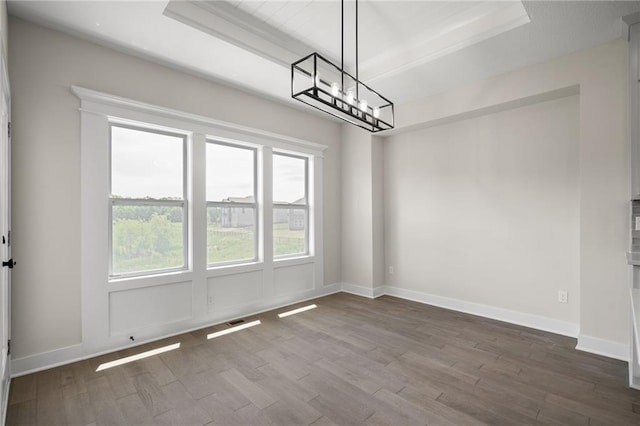 19389 W 114th Ter, Olathe, KS 66061 - unfurnished dining area featuring a chandelier, dark wood-style floors, a raised ceiling, and baseboards