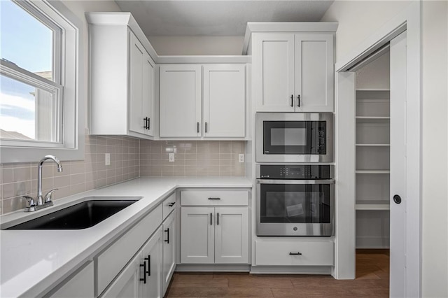 19389 W 114th Ter, Olathe, KS 66061 - kitchen featuring appliances with stainless steel finishes, a sink, light countertops, and healthy amount of natural light