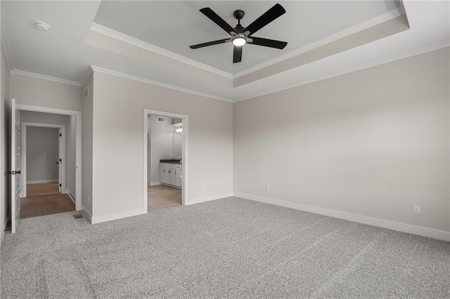19389 W 114th Ter, Olathe, KS 66061 - unfurnished bedroom featuring a raised ceiling, light colored carpet, ornamental molding, baseboards, and ceiling fan