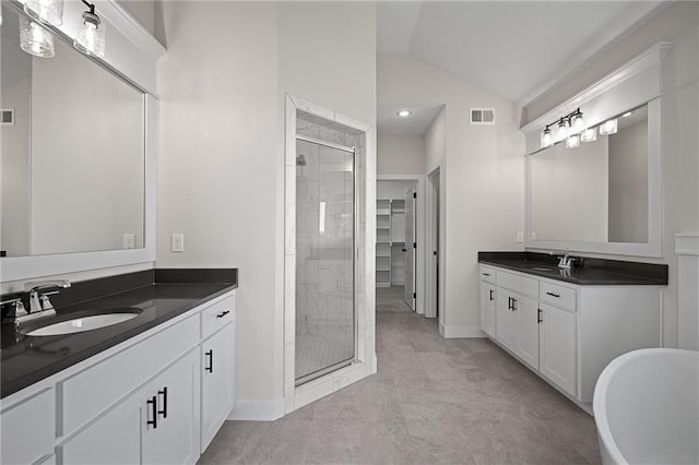19389 W 114th Ter, Olathe, KS 66061 - full bathroom featuring a shower stall, baseboards, vaulted ceiling, two vanities, and a freestanding bath