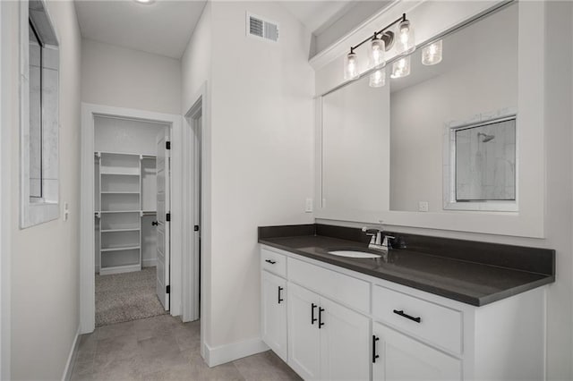 19389 W 114th Ter, Olathe, KS 66061 - bathroom featuring baseboards, vanity, and a spacious closet