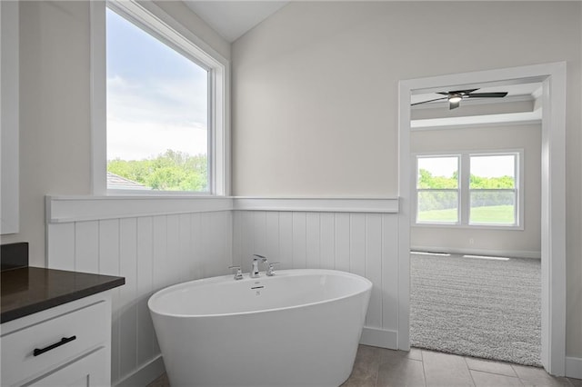 19389 W 114th Ter, Olathe, KS 66061 - bathroom featuring a wainscoted wall, a soaking tub, and vanity