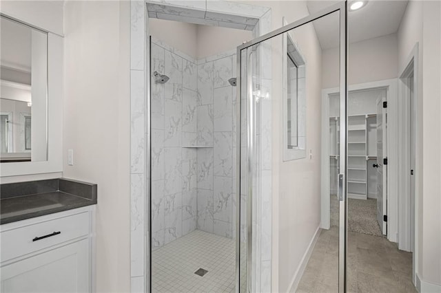 19389 W 114th Ter, Olathe, KS 66061 - bathroom with a shower stall, vanity, baseboards, a spacious closet, and recessed lighting