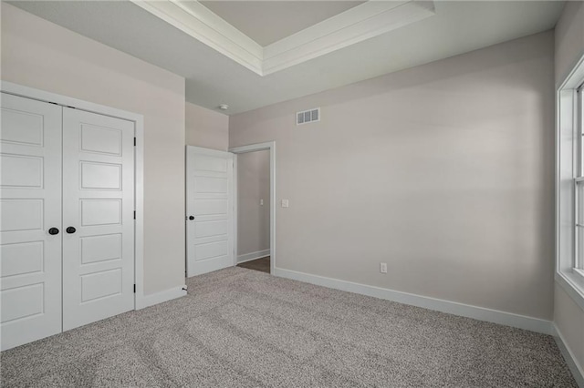 19389 W 114th Ter, Olathe, KS 66061 - unfurnished bedroom featuring carpet floors, a raised ceiling, a closet, and baseboards