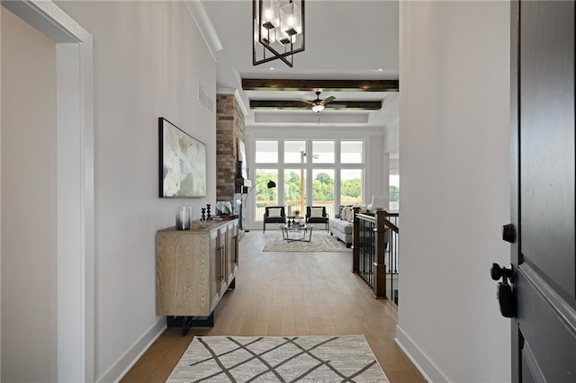 19389 W 114th Ter, Olathe, KS 66061 - foyer featuring light wood finished floors, a ceiling fan, beam ceiling, and a chandelier