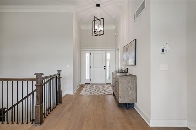 19389 W 114th Ter, Olathe, KS 66061 - entryway with hardwood / wood-style floors, a chandelier, and crown molding