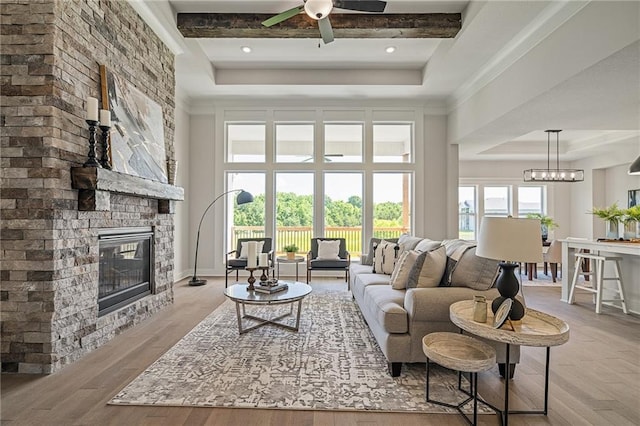 19389 W 114th Ter, Olathe, KS 66061 - living area with a raised ceiling, a fireplace, and wood finished floors