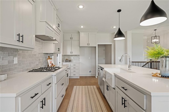 19389 W 114th Ter, Olathe, KS 66061 - kitchen featuring stainless steel appliances, white cabinets, recessed lighting, tasteful backsplash, and hanging light fixtures