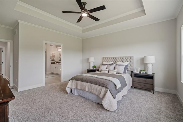 19389 W 114th Ter, Olathe, KS 66061 - carpeted bedroom with a tray ceiling, ornamental molding, ensuite bath, and ceiling fan