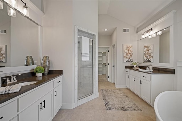 19389 W 114th Ter, Olathe, KS 66061 - bathroom with a stall shower, two vanities, lofted ceiling, a freestanding bath, and tile patterned flooring