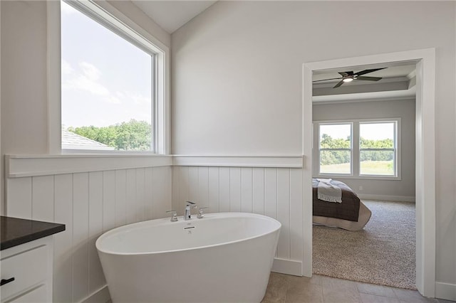 19389 W 114th Ter, Olathe, KS 66061 - bathroom with a freestanding tub, wainscoting, vanity, and ensuite bath
