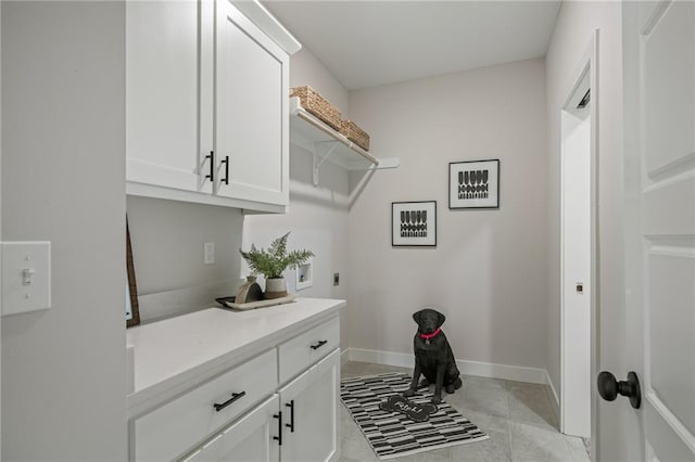19389 W 114th Ter, Olathe, KS 66061 - washroom with cabinet space, electric dryer hookup, and light tile patterned floors