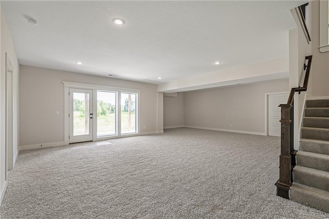 19389 W 114th Ter, Olathe, KS 66061 - unfurnished living room with carpet floors, stairs, and recessed lighting