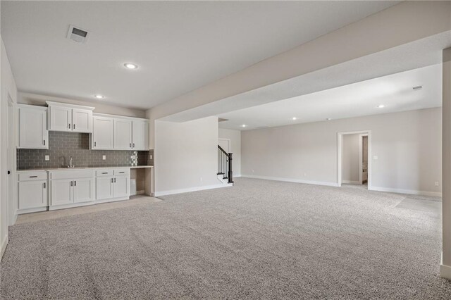 19389 W 114th Ter, Olathe, KS 66061 - unfurnished living room with stairway, recessed lighting, and light colored carpet