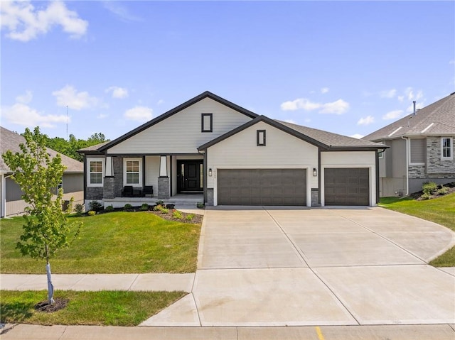 19389 W 114th Ter, Olathe, KS 66061 - view of front of home with covered porch, a garage, concrete driveway, a front yard, and stone siding