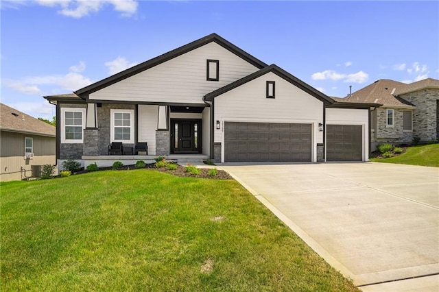 19389 W 114th Ter, Olathe, KS 66061 - view of front of property featuring stone siding, a garage, a front yard, and concrete driveway