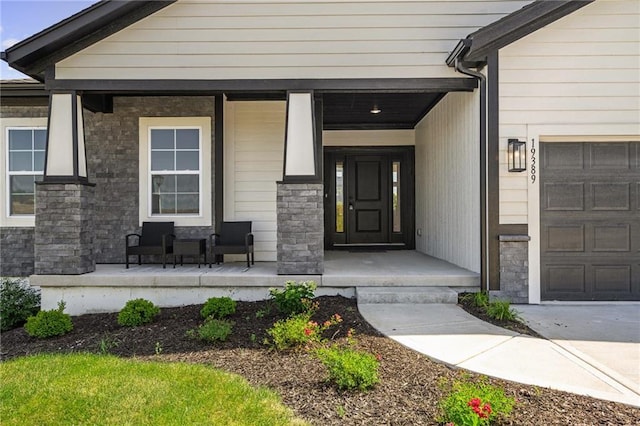 19389 W 114th Ter, Olathe, KS 66061 - property entrance featuring a porch, a garage, and stone siding