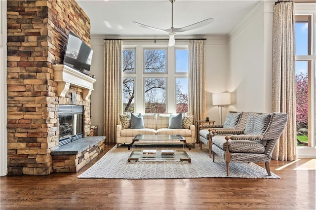 4319 N Mulberry Dr, Kansas City, MO 64116 - sitting room featuring crown molding, wood finished floors, a ceiling fan, and a stone fireplace