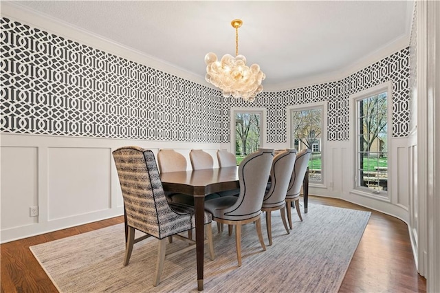 4319 N Mulberry Dr, Kansas City, MO 64116 - dining space featuring wainscoting, an inviting chandelier, crown molding, and a decorative wall