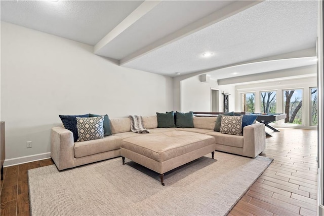 4319 N Mulberry Dr, Kansas City, MO 64116 - living area featuring a textured ceiling, wood finished floors, and baseboards