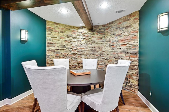 4319 N Mulberry Dr, Kansas City, MO 64116 - dining area featuring beam ceiling, a textured ceiling, visible vents, baseboards, and wood finish floors