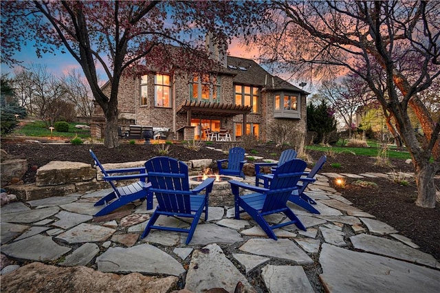 4319 N Mulberry Dr, Kansas City, MO 64116 - rear view of property with a pergola, an outdoor fire pit, a patio, and brick siding
