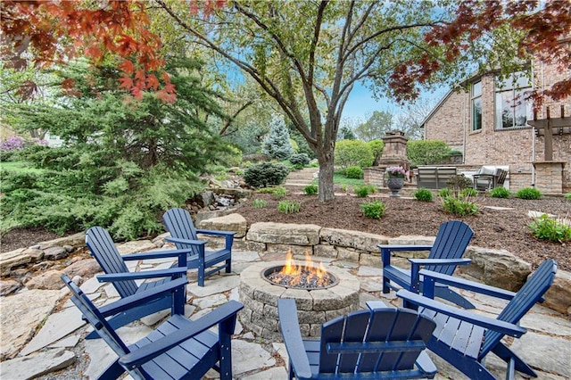 4319 N Mulberry Dr, Kansas City, MO 64116 - view of patio featuring an outdoor stone fireplace and an outdoor fire pit