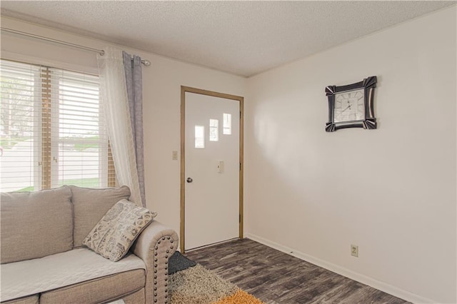 435 NE 41st Ter, Kansas City, MO 64116 - living area with baseboards, a textured ceiling, and dark wood-style floors