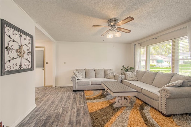 435 NE 41st Ter, Kansas City, MO 64116 - living room featuring baseboards, a textured ceiling, a ceiling fan, and wood finished floors