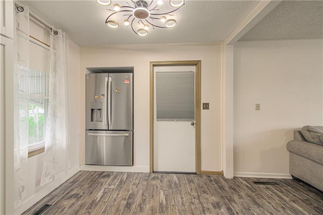 435 NE 41st Ter, Kansas City, MO 64116 - kitchen with a chandelier, a textured ceiling, dark wood-style floors, and stainless steel refrigerator with ice dispenser