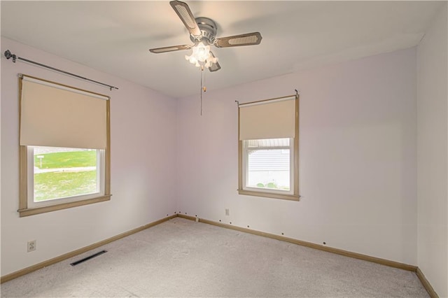 435 NE 41st Ter, Kansas City, MO 64116 - empty room featuring a healthy amount of sunlight, carpet flooring, and visible vents