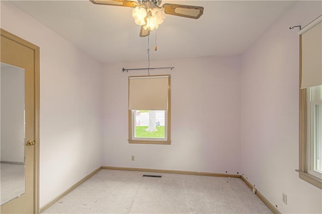 435 NE 41st Ter, Kansas City, MO 64116 - empty room featuring a wealth of natural light, a ceiling fan, and light carpet