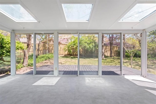 unfurnished sunroom featuring a skylight