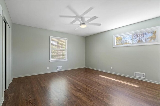 unfurnished bedroom featuring visible vents, baseboards, wood finished floors, and a closet
