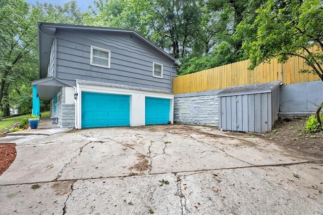 1477 Spruce Ave, Liberty, MO 64068 - garage with driveway and fence