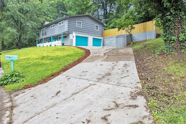1477 Spruce Ave, Liberty, MO 64068 - exterior space with an attached garage, fence, a lawn, and driveway