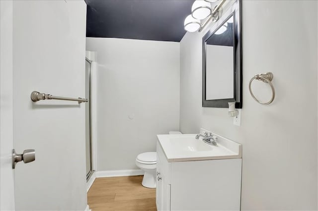1477 Spruce Ave, Liberty, MO 64068 - bathroom featuring vanity, baseboards, toilet, a shower stall, and wood finished floors