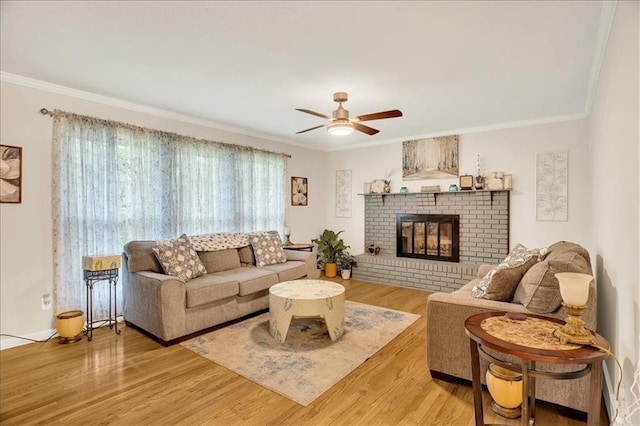 1477 Spruce Ave, Liberty, MO 64068 - living area featuring a fireplace, crown molding, a ceiling fan, and wood finished floors