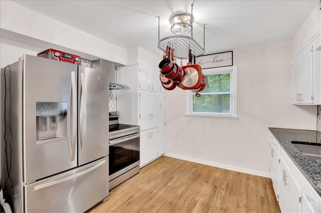 1477 Spruce Ave, Liberty, MO 64068 - kitchen with light wood-style flooring, electric range, white cabinets, stainless steel refrigerator with ice dispenser, and baseboards