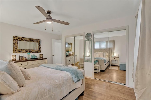 1477 Spruce Ave, Liberty, MO 64068 - bedroom with light wood-style flooring, multiple closets, and ceiling fan