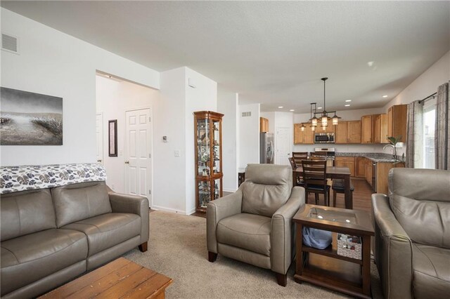 1423 SW Fairfax Rd, Lees Summit, MO 64083 - living room with light colored carpet, recessed lighting, and a chandelier