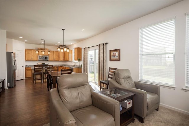 1423 SW Fairfax Rd, Lees Summit, MO 64083 - living room with a chandelier, recessed lighting, and dark wood-type flooring