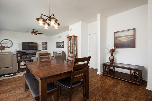 1423 SW Fairfax Rd, Lees Summit, MO 64083 - dining space featuring dark wood-style flooring, ceiling fan, and a chandelier