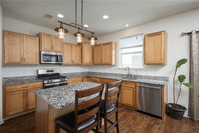 1423 SW Fairfax Rd, Lees Summit, MO 64083 - kitchen featuring appliances with stainless steel finishes, recessed lighting, dark stone countertops, and dark wood finished floors