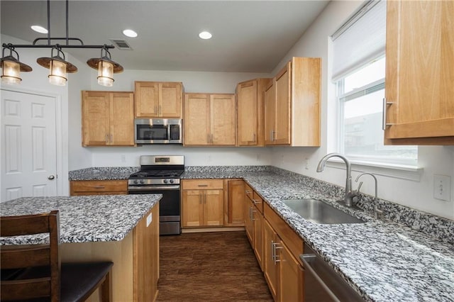 1423 SW Fairfax Rd, Lees Summit, MO 64083 - kitchen featuring appliances with stainless steel finishes, light stone countertops, recessed lighting, pendant lighting, and a breakfast bar area