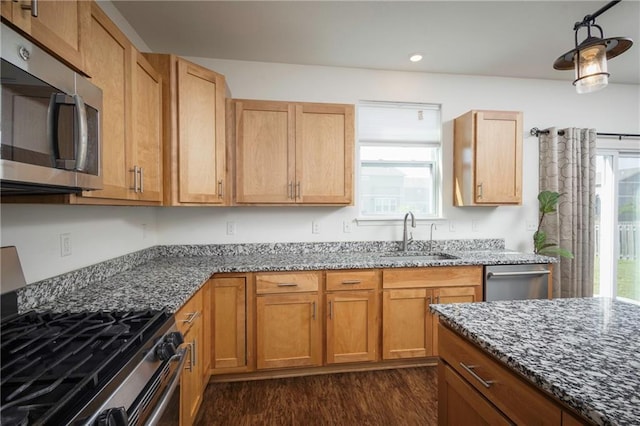 1423 SW Fairfax Rd, Lees Summit, MO 64083 - kitchen featuring stainless steel appliances, plenty of natural light, dark stone counters, dark wood finished floors, and recessed lighting