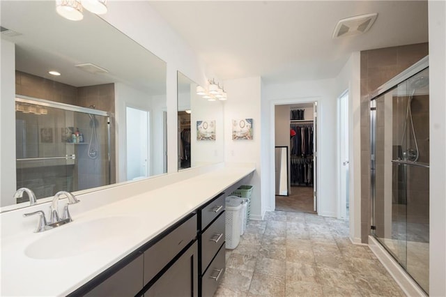 1423 SW Fairfax Rd, Lees Summit, MO 64083 - bathroom featuring a walk in closet, vanity, and a stall shower