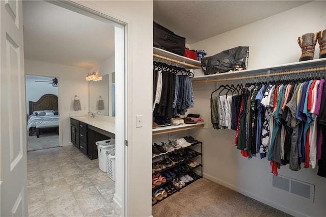 1423 SW Fairfax Rd, Lees Summit, MO 64083 - walk in closet with a ceiling fan and a sink
